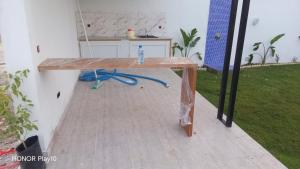 a wooden table in a room with a counter at Elin house in Hammamet
