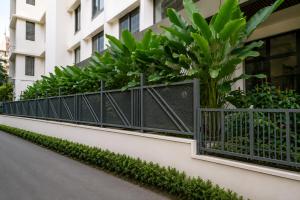 a balcony with plants on a building at K Grandeur Hotels- South Railway Station in Cochin