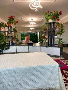 a room with a table and a tv and plants at Khan-toru in Pokrovka