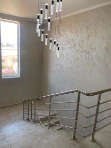 a staircase in a building with a chandelier at Khan-toru in Pokrovka