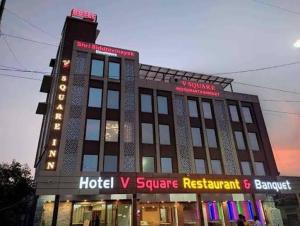 a large building with a hotel v square restaurant at Hotel V Square in Lucknow