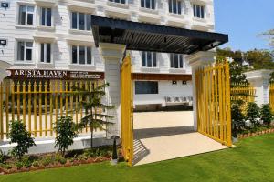 a yellow gate in front of a building at Arista Haven Hotel in Rishīkesh