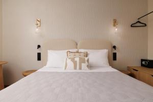 a bedroom with a large bed with white sheets and pillows at Avia in Corfu