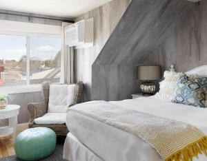 a bedroom with a large bed and a window at The Boathouse in Kennebunkport