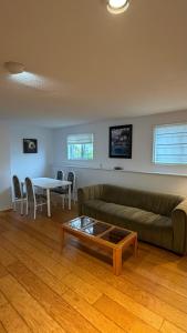 a living room with a couch and a table at Urban Midtown Stays in St. John's