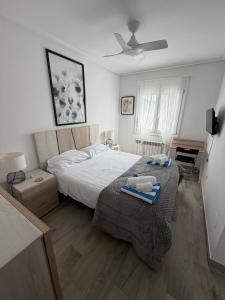 a bedroom with a bed with two towels on it at Beautiful 3 bed villa on Mar Menor golf resort in Torre-Pacheco +26 photos