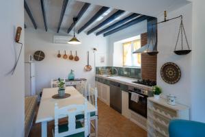 a kitchen with a table and a dining room at Casa Altavista in Alora +20 photos