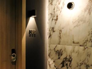 a bathroom with a shower with a clock on the wall at SonoLux in Montreal
