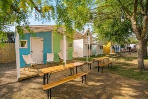 a group of tables and chairs in front of a house at Kampaoh El Palmar in El Palmar +76 photos