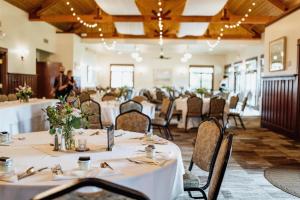 a banquet hall with tables and chairs with people in the background at Chico Hot Springs Resort in White City +217 photos