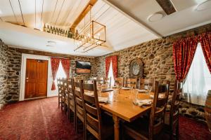 a dining room with a long wooden table and chairs at Chico Hot Springs Resort in White City