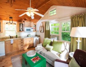 a living room with a couch and a kitchen at The Cottages at Cabot Cove in Kennebunkport