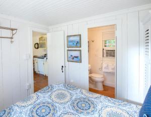 a bedroom with a bed and a bathroom with a toilet at The Cottages at Cabot Cove in Kennebunkport +229 photos