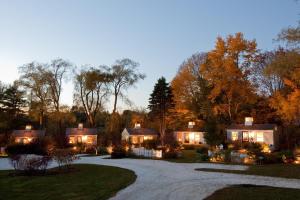 a home in the woods at dusk at The Cottages at Cabot Cove in Kennebunkport