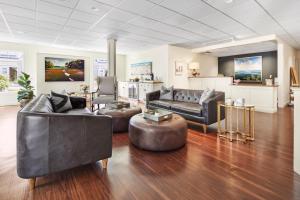 a living room with two couches and a table at The Grand Hotel in Kennebunk
