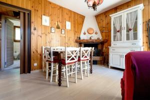 a dining room with wooden walls and a table and chairs at Un piccolo nido accogliente in Fanano +5 photos