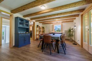 a kitchen and dining room with a table and chairs at Chalet des Cheneaux in Bruson