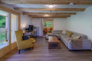 a living room with a couch and two chairs at Chalet des Cheneaux in Bruson