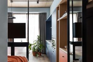 a bedroom with blue walls and a large window at Beckett Locke in Dublin +16 photos