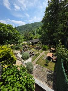 a view of a garden with benches and tables at Özde Dağ Evi in Sapanca
