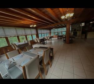 a dining room with tables and chairs in a building at Özde Dağ Evi in Sapanca