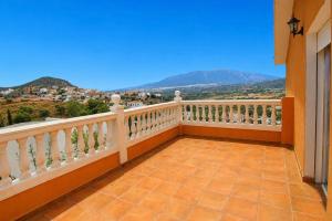 a balcony with a white railing and a view at Bello horizonte in Coín