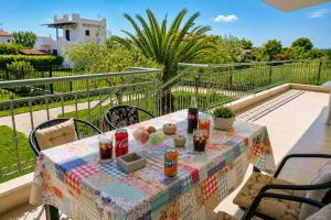 a table with drinks and food on a balcony at Olive Garden Vila in Karianí
