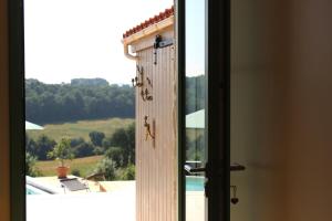 an open door with a view of a window at Lôu cayrou in Beaumarches