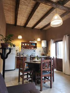 a kitchen and dining room with a table and chairs at La Gauda in Huacalera