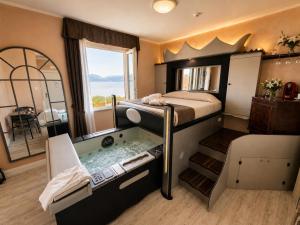 a bedroom with a bed and a bath tub in it at Hotel Butterfly in Torre del Lago Puccini