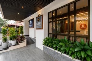 a store with potted plants outside of it at K Grandeur Hotels- South Railway Station in Cochin