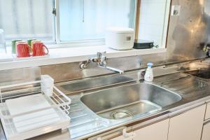 a kitchen counter with a sink and a mixer at Kokonimo Kawagoesenba in Kawagoe +55 photos