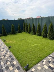 a yard with a bunch of trees and a fence at Villa Menorca in Chornomorsk +28 photos