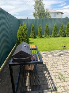 a grill sitting on a table in a backyard at Villa Menorca in Chornomorsk