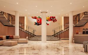 a lobby of a building with stairs and a sculpture at The William Vale in Brooklyn