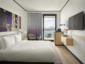 a hotel room with a bed and a tv at The William Vale in Brooklyn