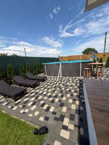 a patio with a checkerboard patterned patio at Villa Menorca in Chornomorsk
