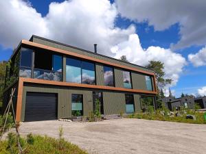 a house with a lot of windows on top of it at maja in Syöte