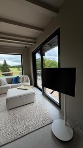 a living room with a flat screen tv and a couch at Chosen Hideaway Near Cologne in Neunkirchen-Seelscheid