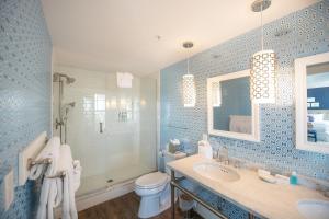 a blue bathroom with a sink and a toilet at The Tides Beach Club in Kennebunkport +156 photos