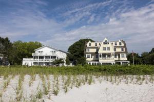 a couple of houses on the beach near the sand at The Tides Beach Club in Kennebunkport