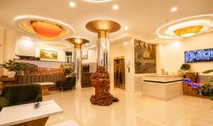 a lobby of a restaurant with a statue in the middle at Lien's 2 Hotel Dalat in Da Lat