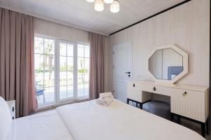 a bedroom with a bed and a mirror and a desk at Astalanya City in Astara