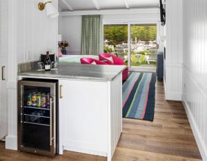 a kitchen with a counter and a living room at Yachtsman Lodge & Marina in Kennebunkport