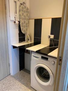 a washing machine in a small kitchen with a counter at Koko home in Baia Mare +32 photos