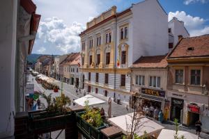 a view of a street in a city with buildings at Barrique 13 - Breakfast at Restaurant & Minibar - Old Town in Braşov
