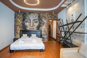 a bedroom with a large painting on the wall at Barrique 13 - Breakfast at Restaurant & Minibar - Old Town in Braşov