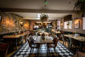 a restaurant with tables and chairs in a room at The Loopy Shrew in Shrewsbury