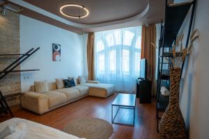 a living room with a couch and a table at Barrique 13 - Breakfast at Restaurant & Minibar - Old Town in Braşov