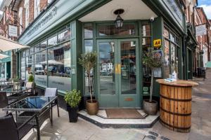 a store front with a green door on a street at The Loopy Shrew in Shrewsbury